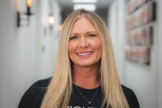 Patient smiling confidently with healthy bone-anchored dental restorations Patient smiling confidently with healthy bone-anchored dental restorations