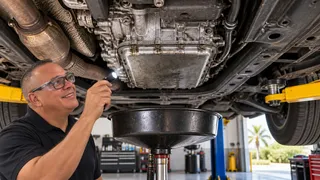 Illustration of Danny diagnosing a transmission issue at Danny Auto Repair in Hudson, Florida.