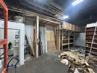 Cluttered commercial warehouse before a Junk Bandits cleanout