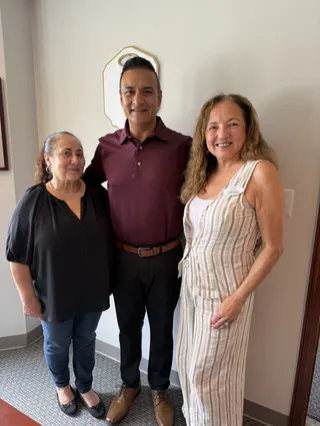 Three people sharing a moment indoors.