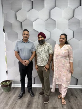 Three people posing for a group photo.