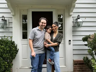 A family gathered by a front door.
