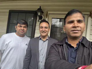 Three people taking a selfie on a porch.