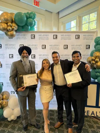 A group posing with certificates at an event.