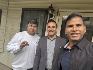 Three people taking a porch selfie.