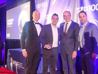 A group on stage at an industry event.