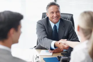 Business professional welcoming customers and discussing their needs