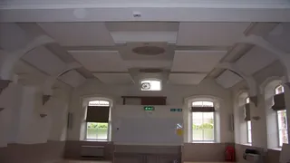 Suspended white ceiling panels beneath the arched roof at Marton cum Grafton Village Hall.