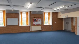 Grey ceiling panels and a wall panel above the blue carpet in Stannington Brass Band's rehearsal room.