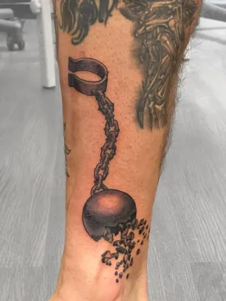 Ball and chain tattoo