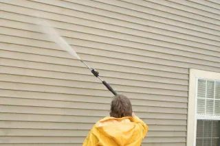 Should I power wash my home before painting?
