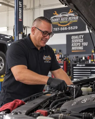 Danny, owner and mechanic at Danny Auto Repair, working under the hood of a vehicle in Hudson, Florida.
