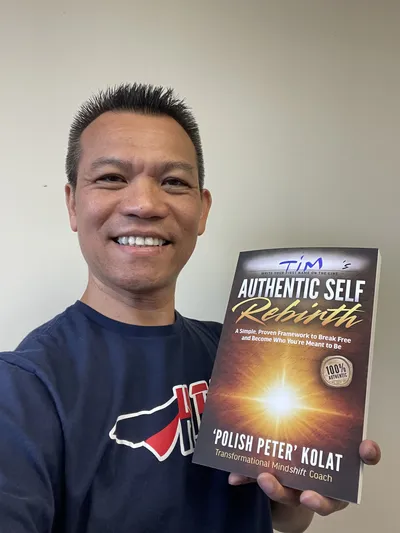 A reader holding Authentic Self Rebirth with his name written on the cover