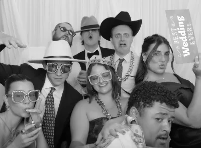 Group wearing cowboy hats and sunglasses at a Photo-N-Go event