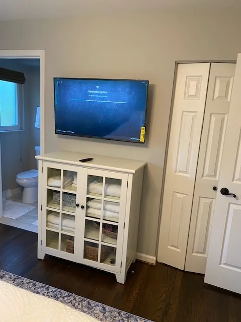 Bedroom TV mounted above a cabinet