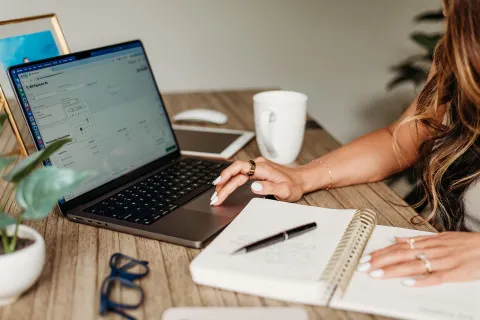 Professional woman working at desk, focused on business tasks