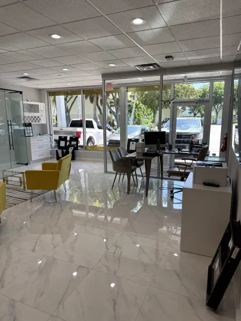 View across the showroom toward the front windows and glass display area