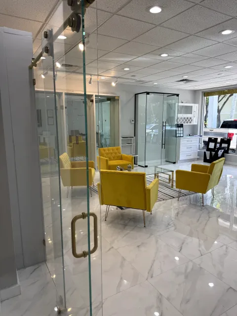 Close view through a glass door with metal handle into the showroom