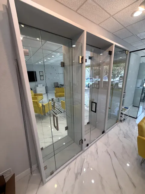Frameless glass shower door displays with metal handles in the Naples showroom