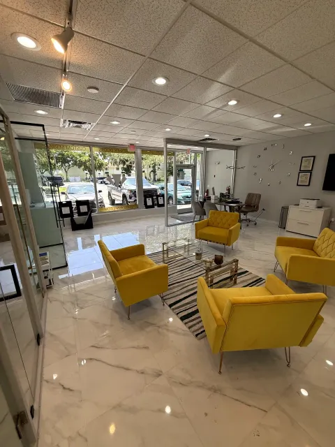 Luxurious Glass showroom with yellow lounge chairs and glass displays