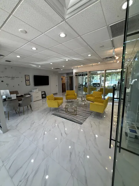 Wide view of the Luxurious Glass showroom with glass displays and lounge seating