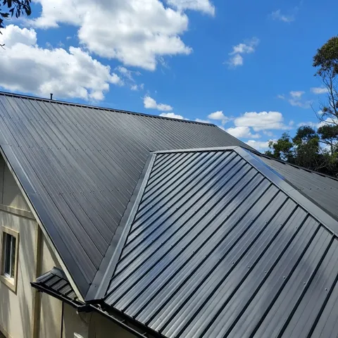 Dark standing seam metal roof on a two-story home