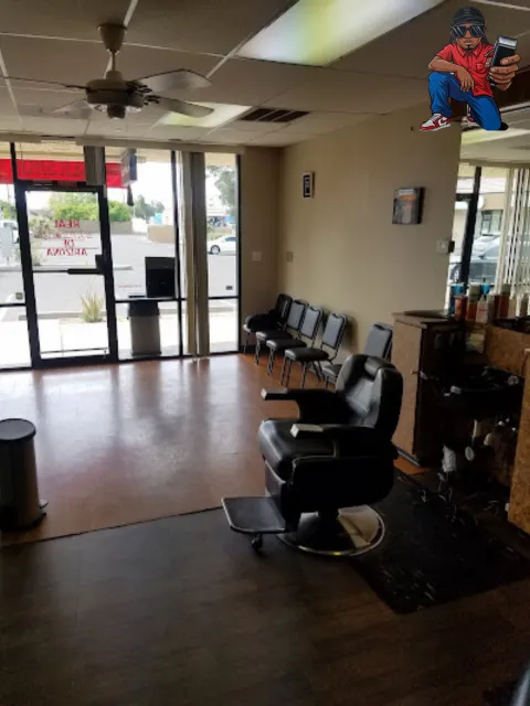 Barber chairs and storefront windows inside Real Barbers of Arizona