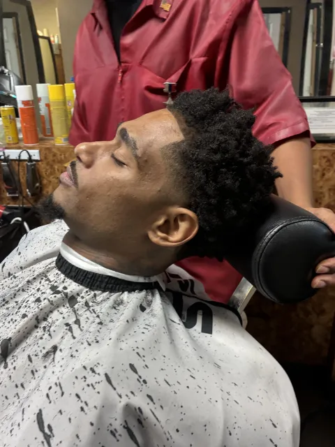 Beard trim in progress in the barber chair