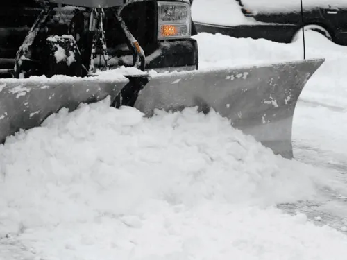 Snow plow blade pushing fresh snow