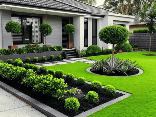Front yard with trimmed shrubs, rock beds and a fresh green lawn