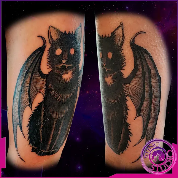 Winged black cat tattoo by Derrick at Sting Studio Ottawa