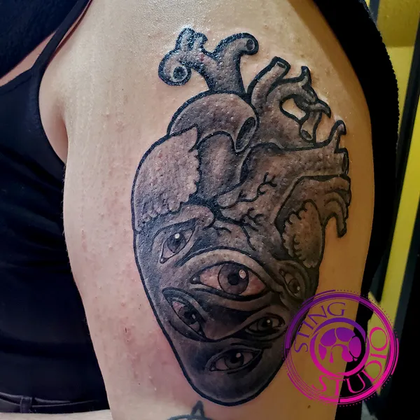 Many eyed heart tattoo by Derrick at Sting Studio Ottawa