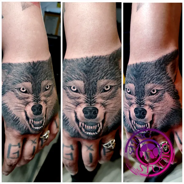 Snarling wolf hand tattoo by Derrick at Sting Studio Ottawa
