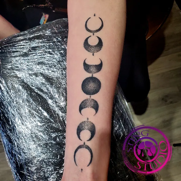 Moon phases blackwork forearm tattoo – Sting Studio Ottawa