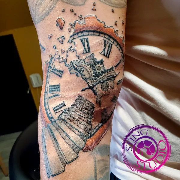 Disintegrating clock tattoo by Derrick at Sting Studio Ottawa