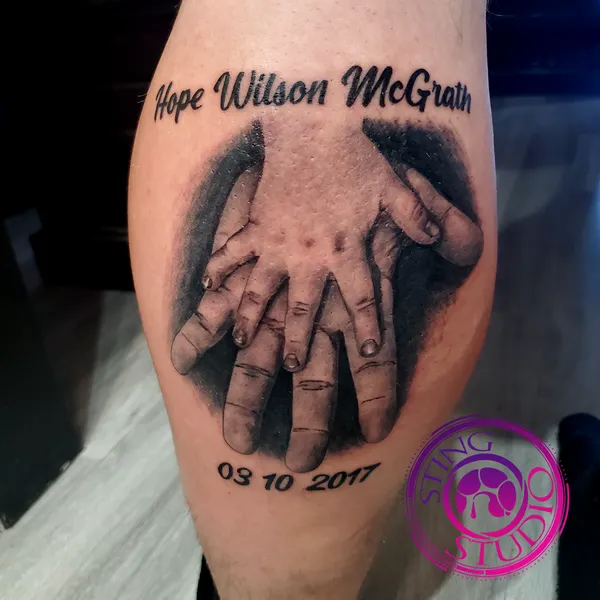 Baby and parent hands tattoo by Derrick at Sting Studio Ottawa