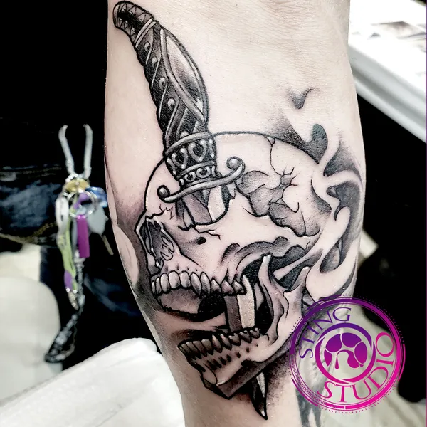 Skull dagger tattoo by Derrick at Sting Studio Ottawa