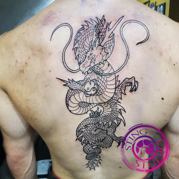 Dragon linework back tattoo by Derrick at Sting Studio Ottawa