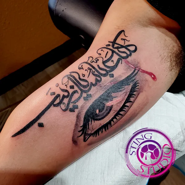 Arabic script and eye tattoo by Derrick at Sting Studio Ottawa