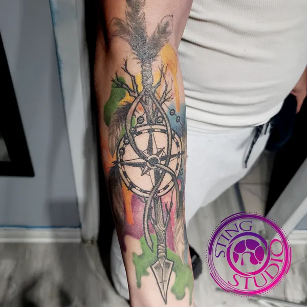 Arrow compass watercolor tattoo by Derrick at Sting Studio Ottawa