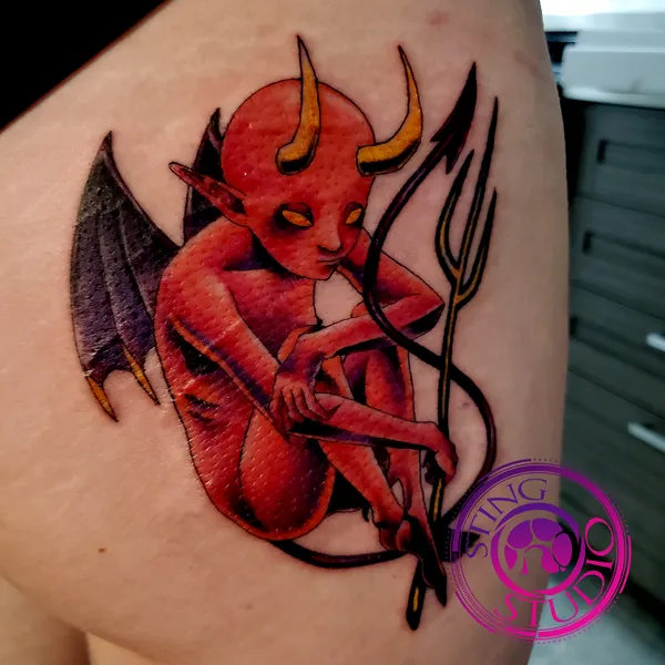 Red devil butt tattoo by Derrick at Sting Studio Ottawa