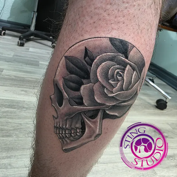 Skull rose tattoo by Derrick at Sting Studio Ottawa
