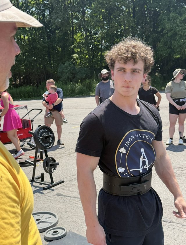 A young athlete competing in a strength event