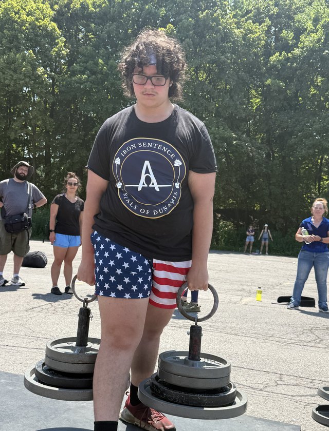 An athlete pushing a sled at a competition