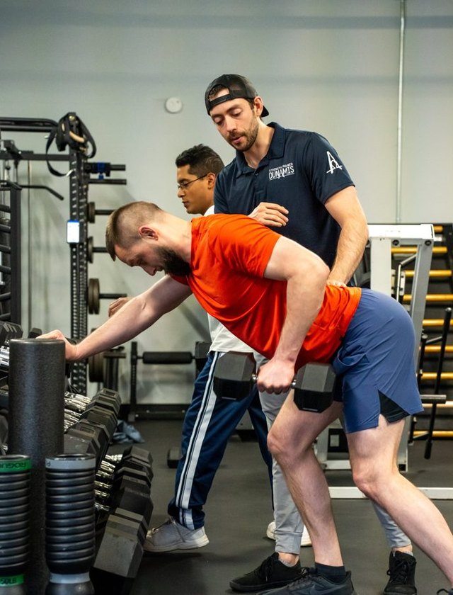 Dumbbell pressing with a coach spotting
