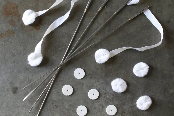 Hand-tufted wool rosettes on The Grand Luxe Mattress by Avocado