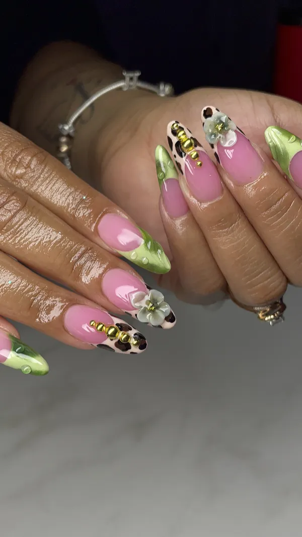 Pink and green floral nail art with 3D charms