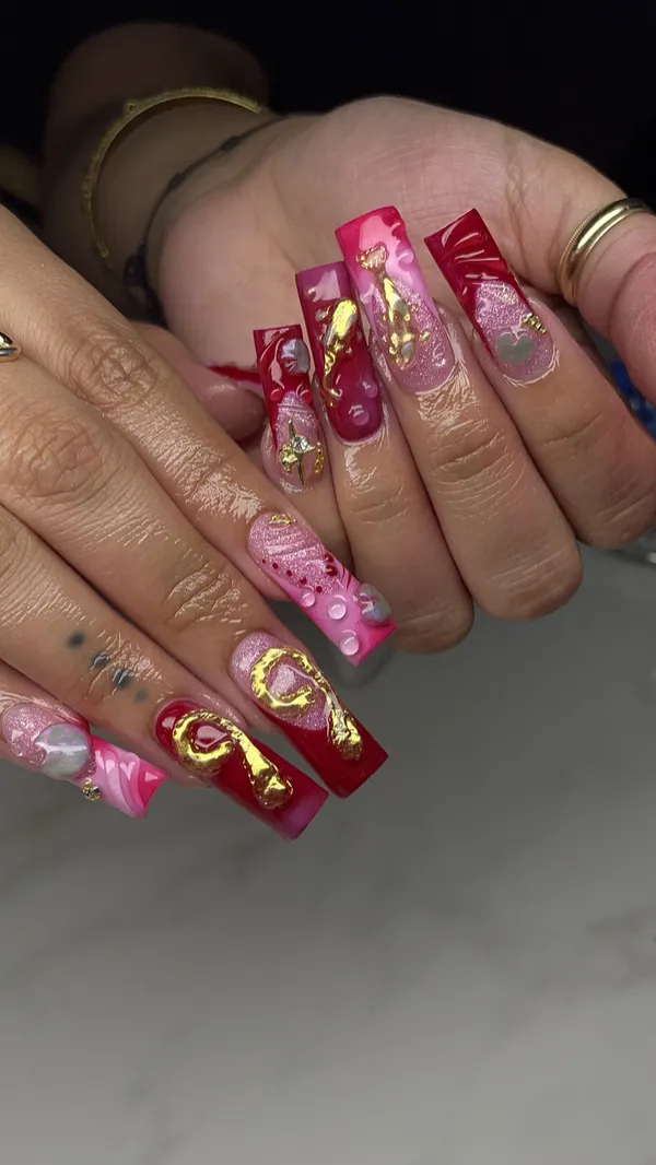 Long red and pink square nails with gold accents