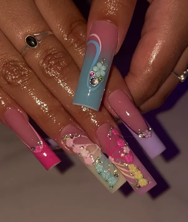 Long pink and blue nails with 3D flowers and gems