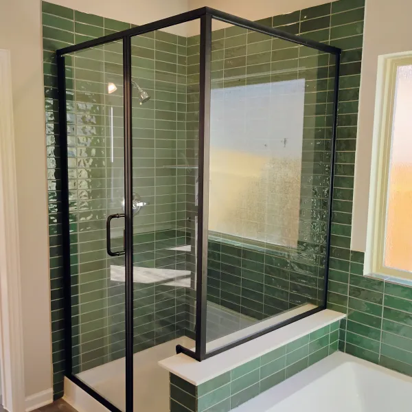 Black-framed shower enclosure with green tile
